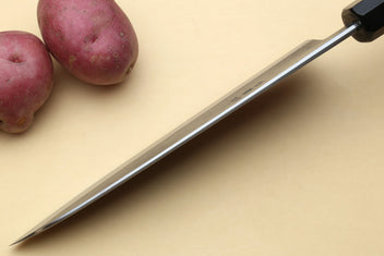 Japanese gyuto chef’s knife with long stainless blade and black handle