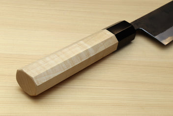 Kaede wooden handle with black collar and part of blue steel kurouchi gyuto blade