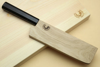 Nakiri knife with black handle and blue-steel blade on light wooden stand