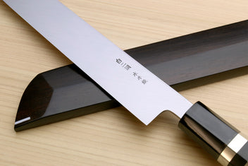 Japanese sushi knife with mirror-finished white blade, ebony handle, and saya