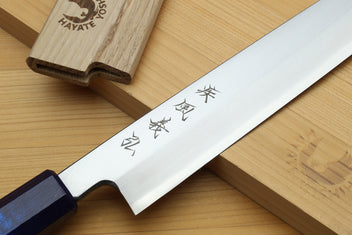 Yanagi sushi knife blade close-up with Japanese characters and dark-blue handle