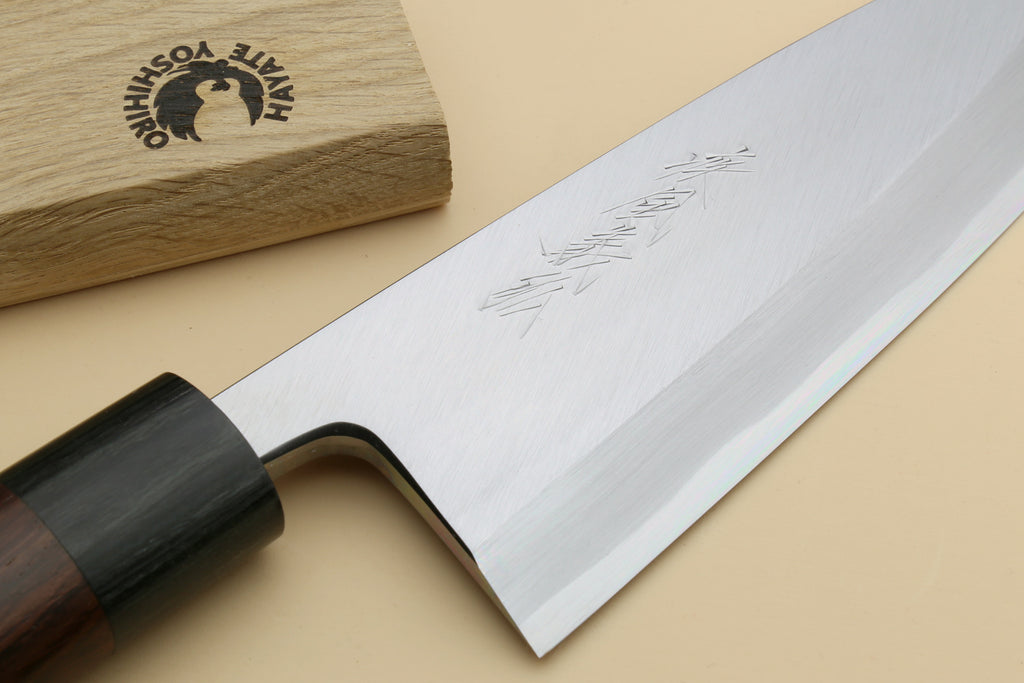 White steel deba knife blade with sharpened edge and black collar, handle not shown