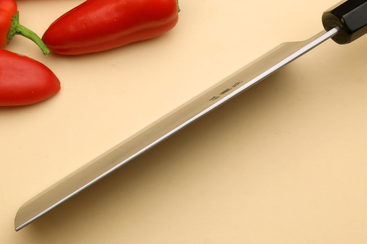 Nakiri vegetable knife side view, long gray blade with black handle