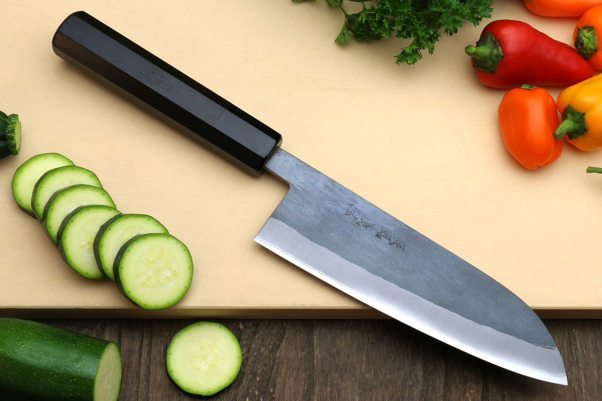 Santoku-style knife with black handle and stainless blade