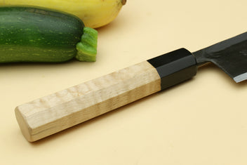 Paring knife with camphor wood handle and dark blade.
