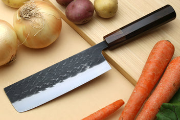 Nakiri knife with dark hammered blade and black handle, white cutting edge