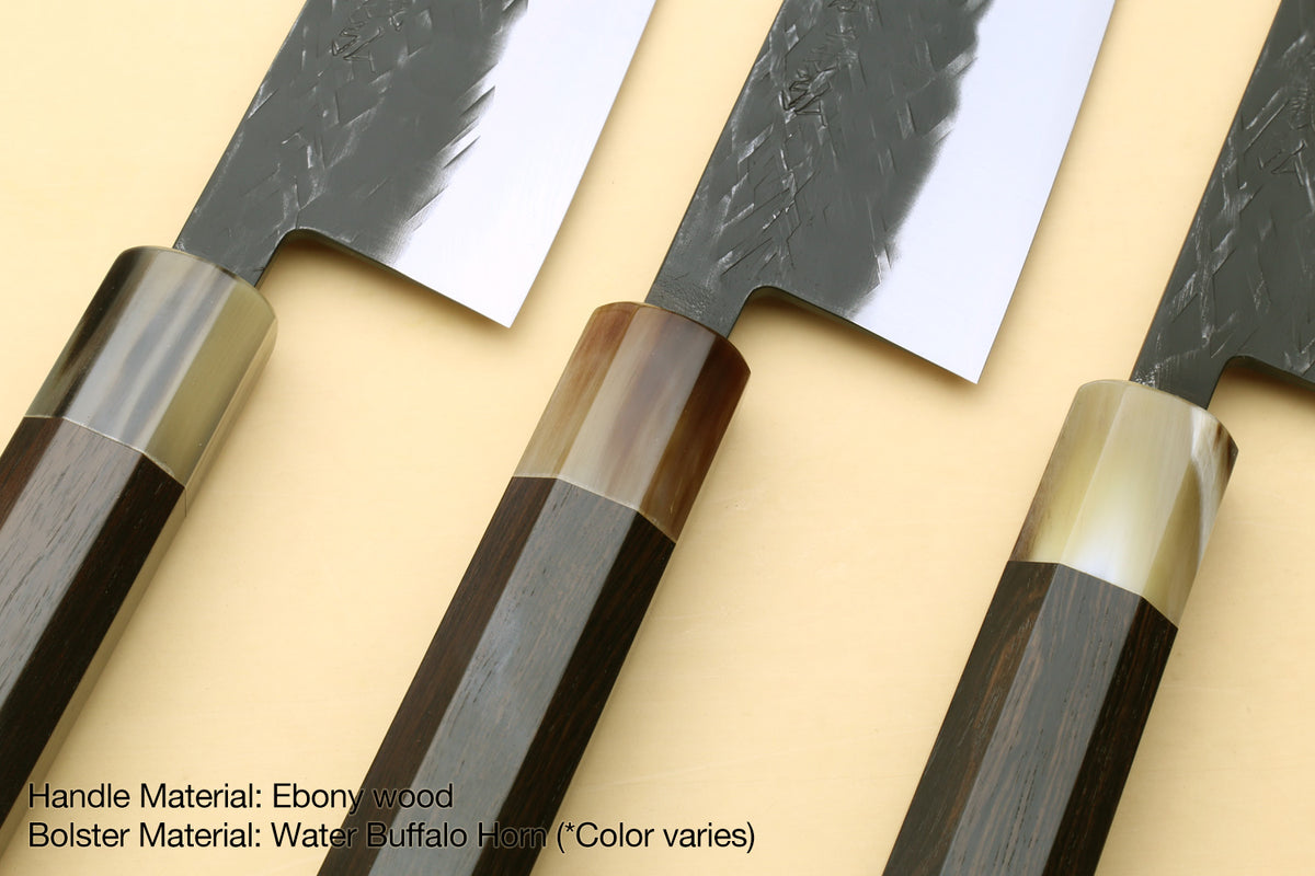 Santoku knife showing ebony-wood handle and silver bolster