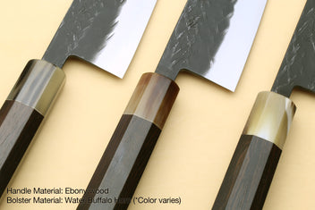 Santoku knife showing ebony-wood handle and silver bolster