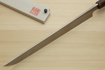 Sashimi sushi knife with long pointed white steel blade and dark handle on wood