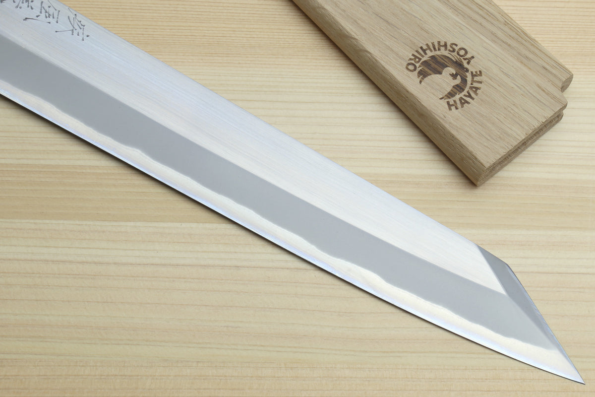 Yanagi-kiritsuke knife showing long white blade, sharp pointed tip