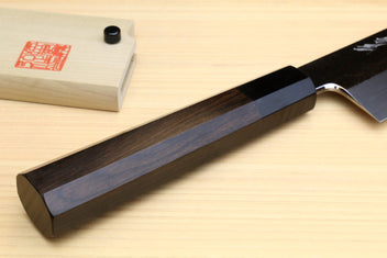 Japanese vegetable knife handle and heel detail with dark ebony grip on wood