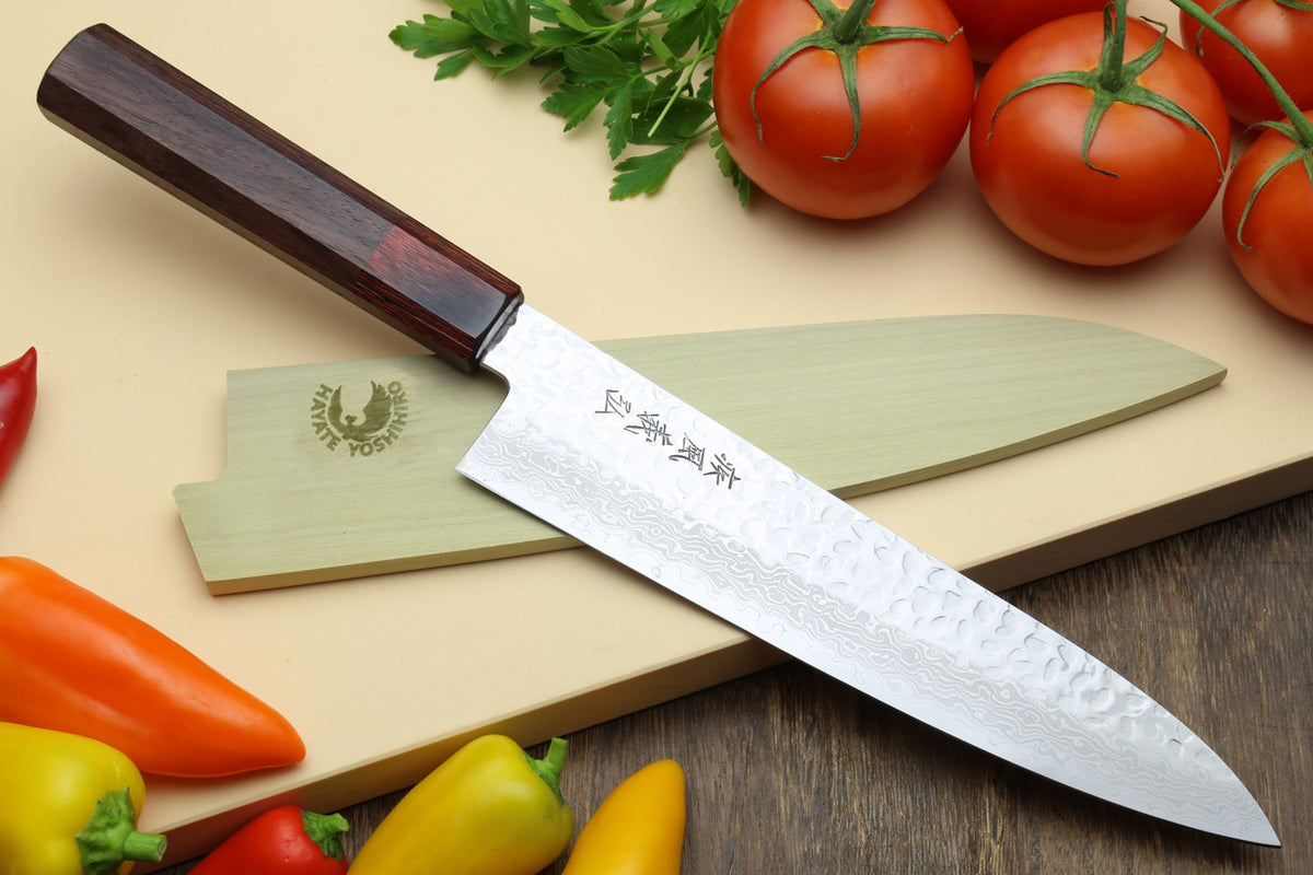 Damascus gyuto chef knife with hammered blade pattern and dark handle