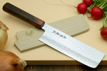 Nakiri vegetable knife at angle with hammered Damascus blade and rosewood handle