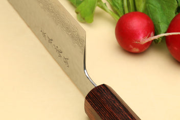 Nakiri vegetable knife close-up of Damascus blade engraving and rosewood handle