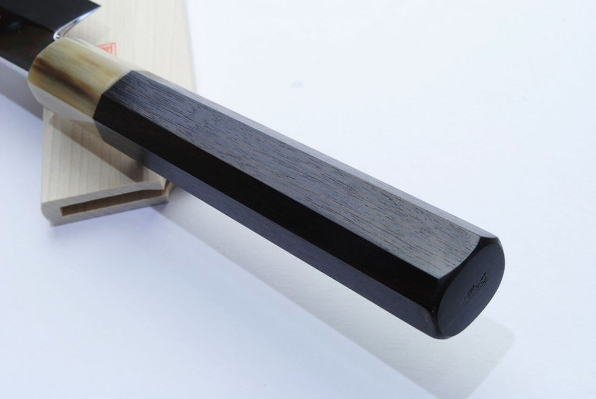 Wood saya with black end cap and dark blade edge; kiritsuke handle visible