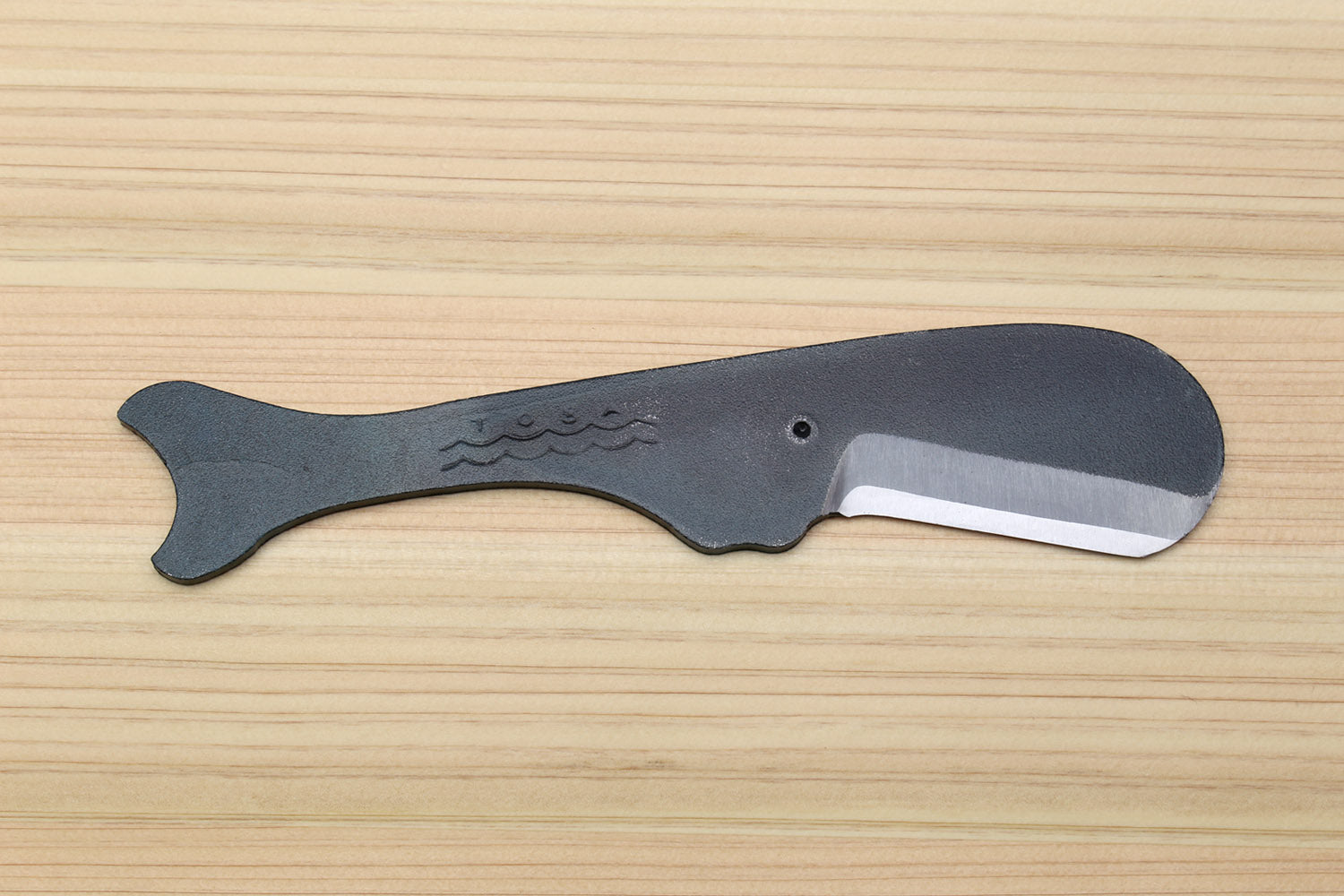 Utility knife with dark kurouchi finish, whale pattern, and silver blade