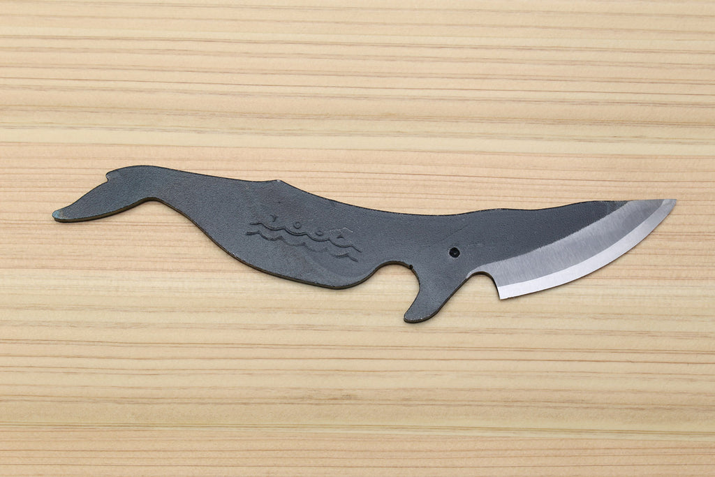Utility knife with dark kurouchi finish, whale pattern, and pointed silver blade tip