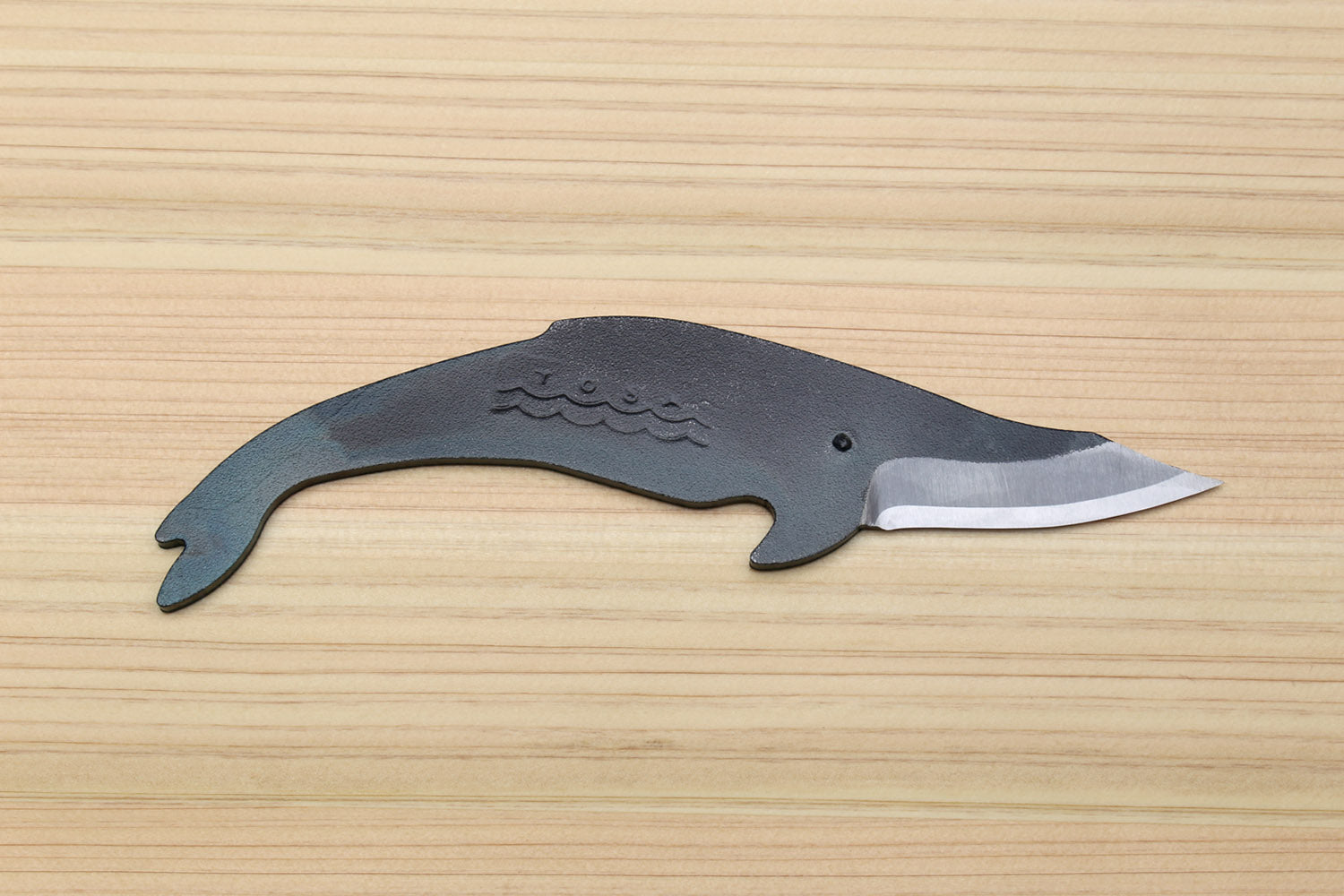 Utility knife with dark kurouchi finish, whale pattern, and silver blade edge