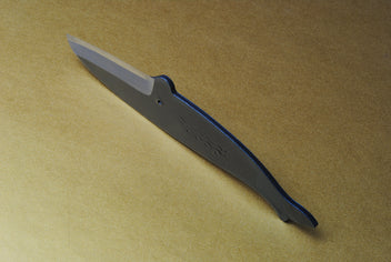Japanese utility knife in dark steel with wave pattern etching along the blade