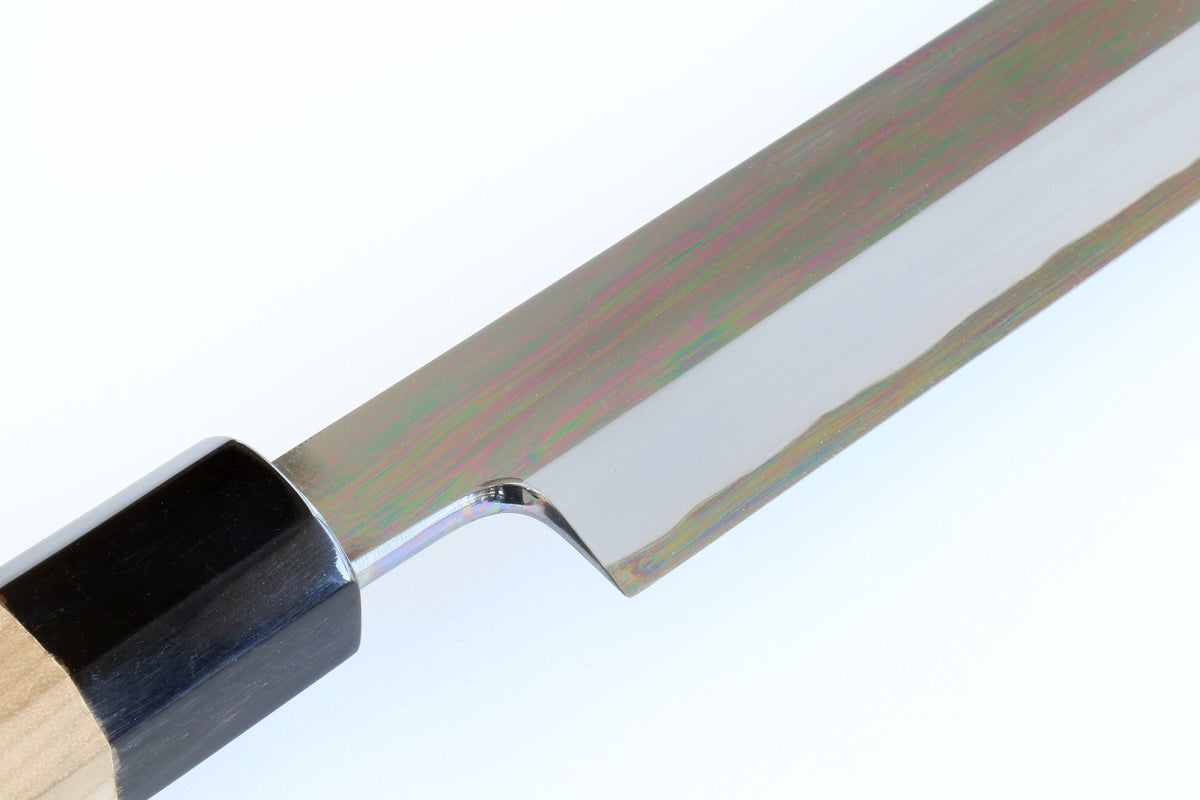 Tuna knife handle and blade junction with black bolster and polished steel