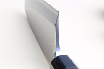 Deba fish fillet knife close-up of steel blade and dark shitan handle