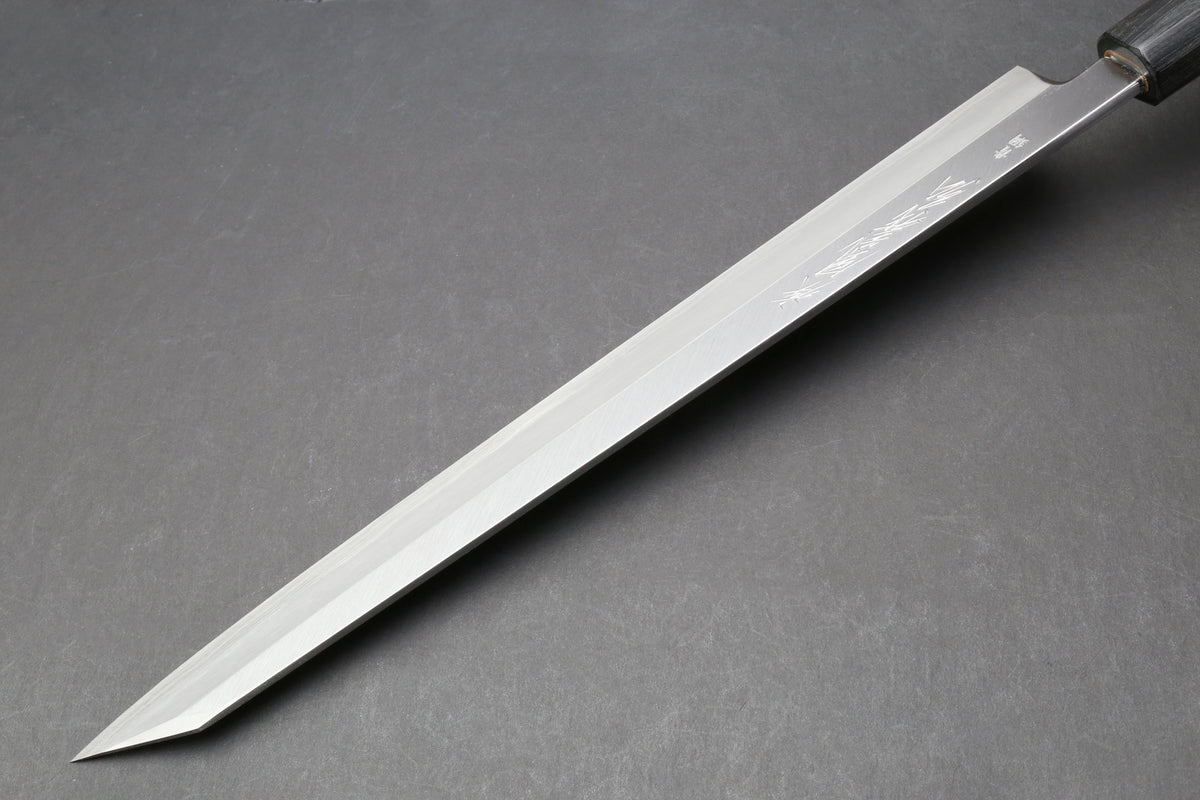 Japanese yanagi knife with long tapered blade and rosewood handle