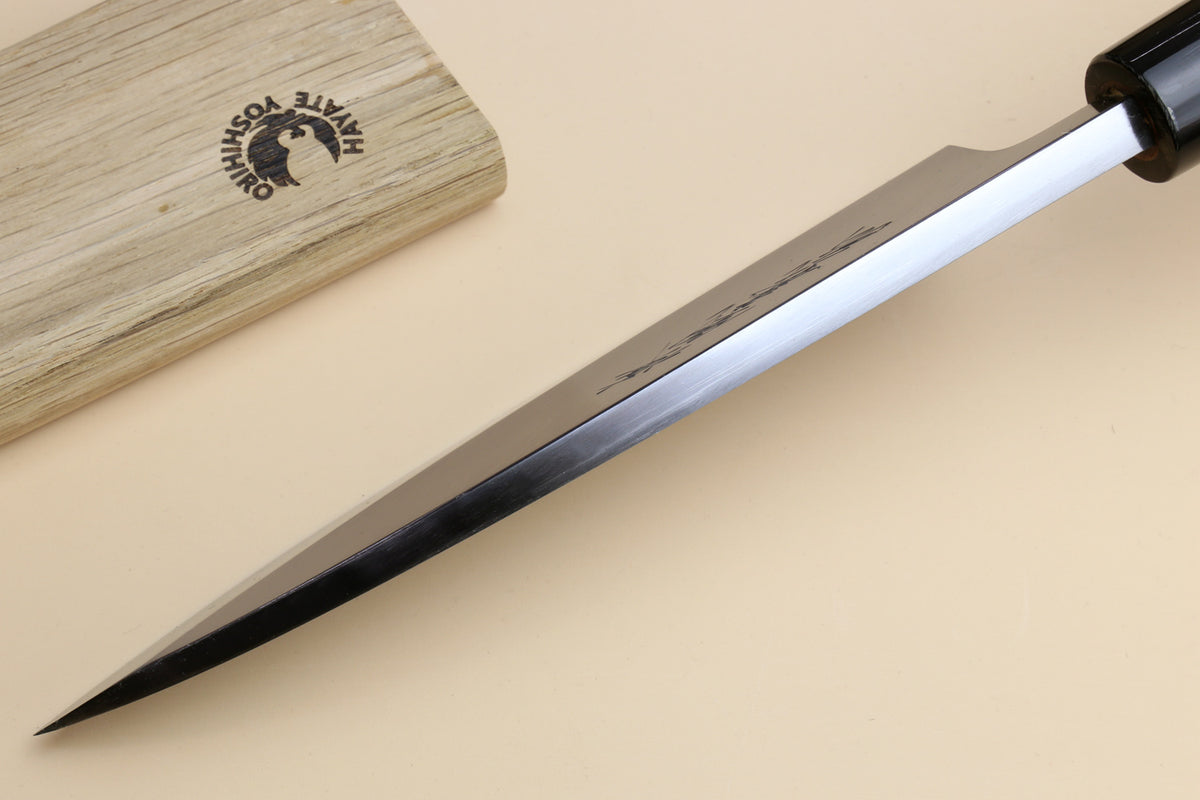 Deba knife shown side view: tapered white steel blade with dark rosewood handle