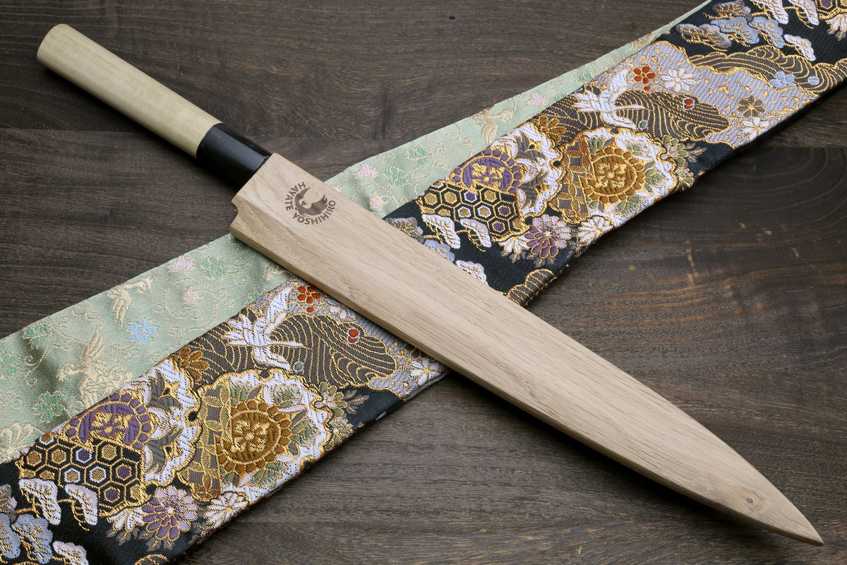 Yanagi sashimi knife with long white blade and black magnolia handle