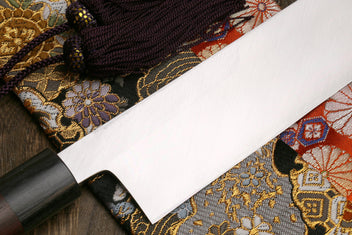White steel vegetable knife with dark handle and tapered blade tip