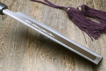 White steel knife with engraved lettering and purple cord tied; dark handle