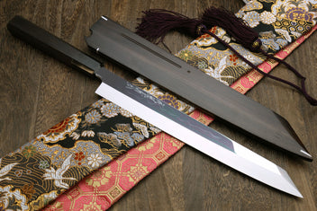 Japanese sushi knife with mirror-finished blade and matching black saya