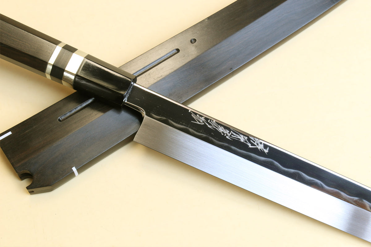 Japanese yanagi knife with mirror-finished steel blade, dark wood handle, and saya