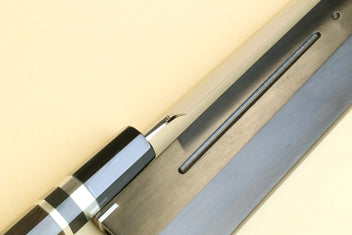 Yanagi knife detail: dark handle with silver checkered ferrule and long blade