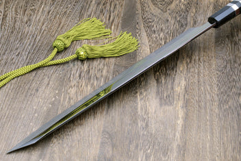 Mirror-finished Japanese knife with dark handle, green cord, and black cloth wrap