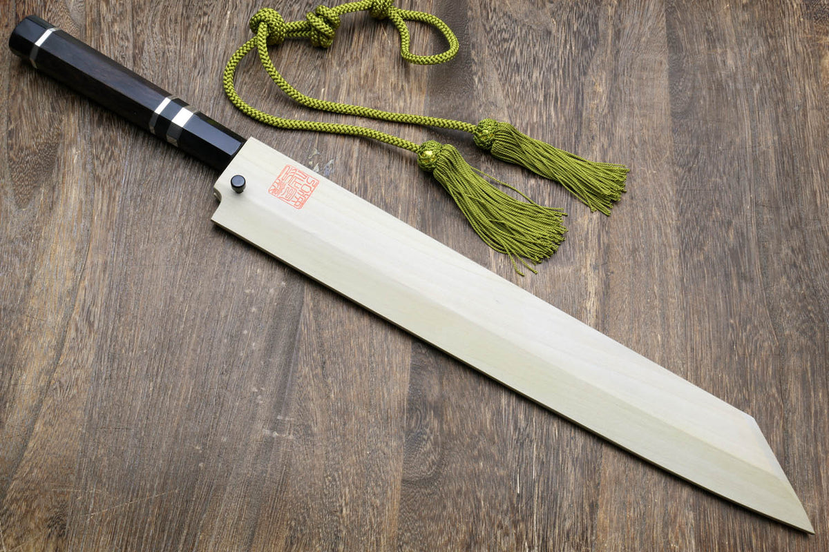 Japanese kitchen knife with dark handle, mirror-finished blade, and green cords