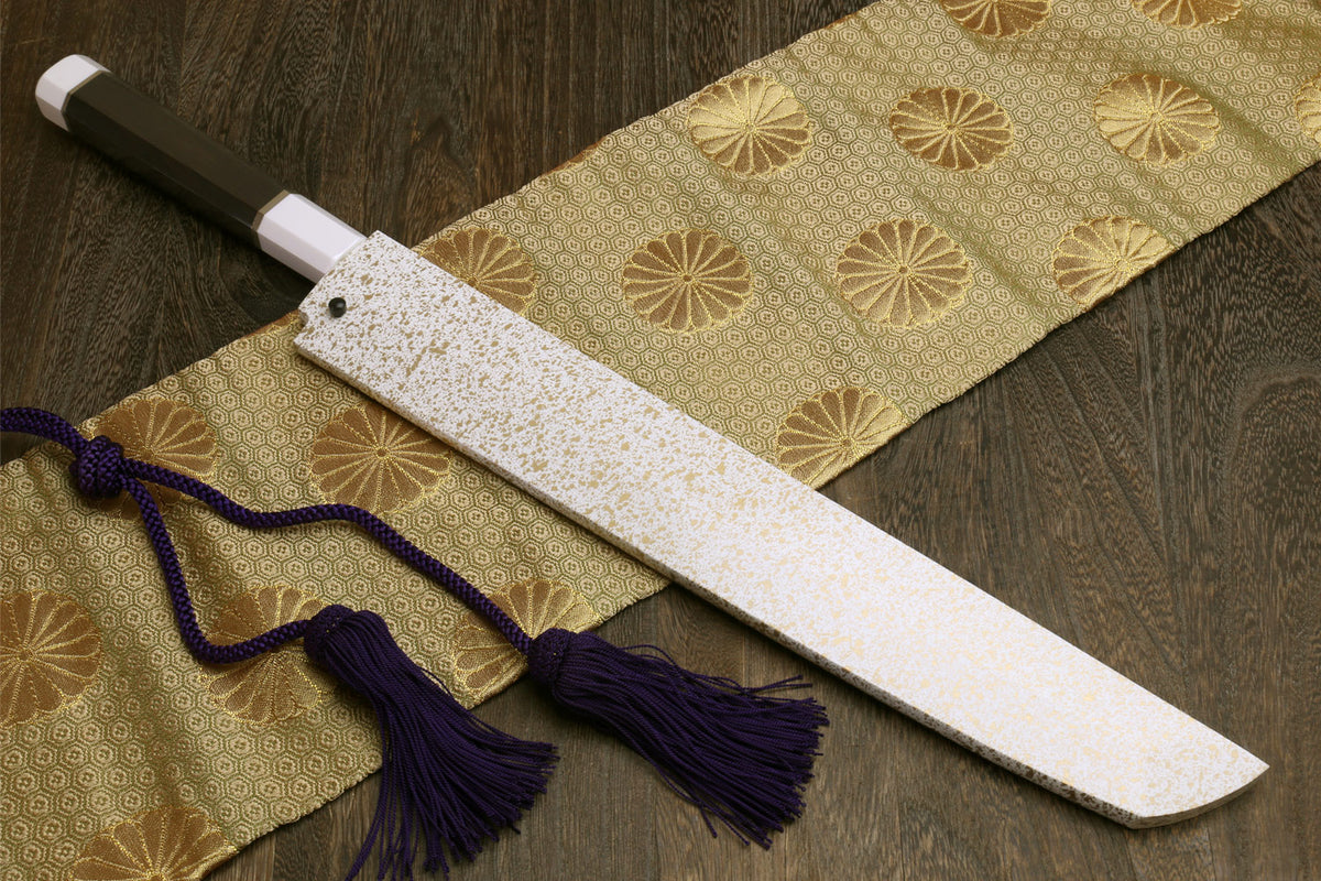 Japanese sushi sashimi knife with speckled white saya and dark handle, purple tassel cord