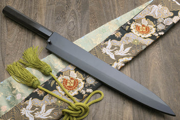 Japanese kitchen knife with black saya, silver blade, ornate cloth wrap and green cord
