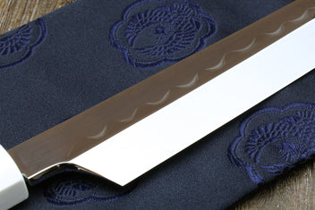 Japanese sushi knife with white steel blade and dark handle on fabric pouch