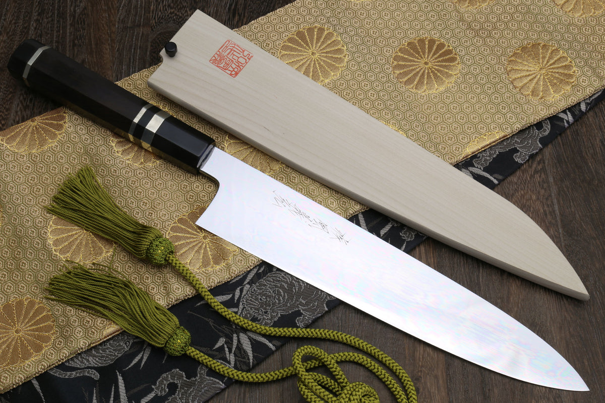 Gyuto Japanese chef knife with mirror-polished blade and ebony handle with striped accents