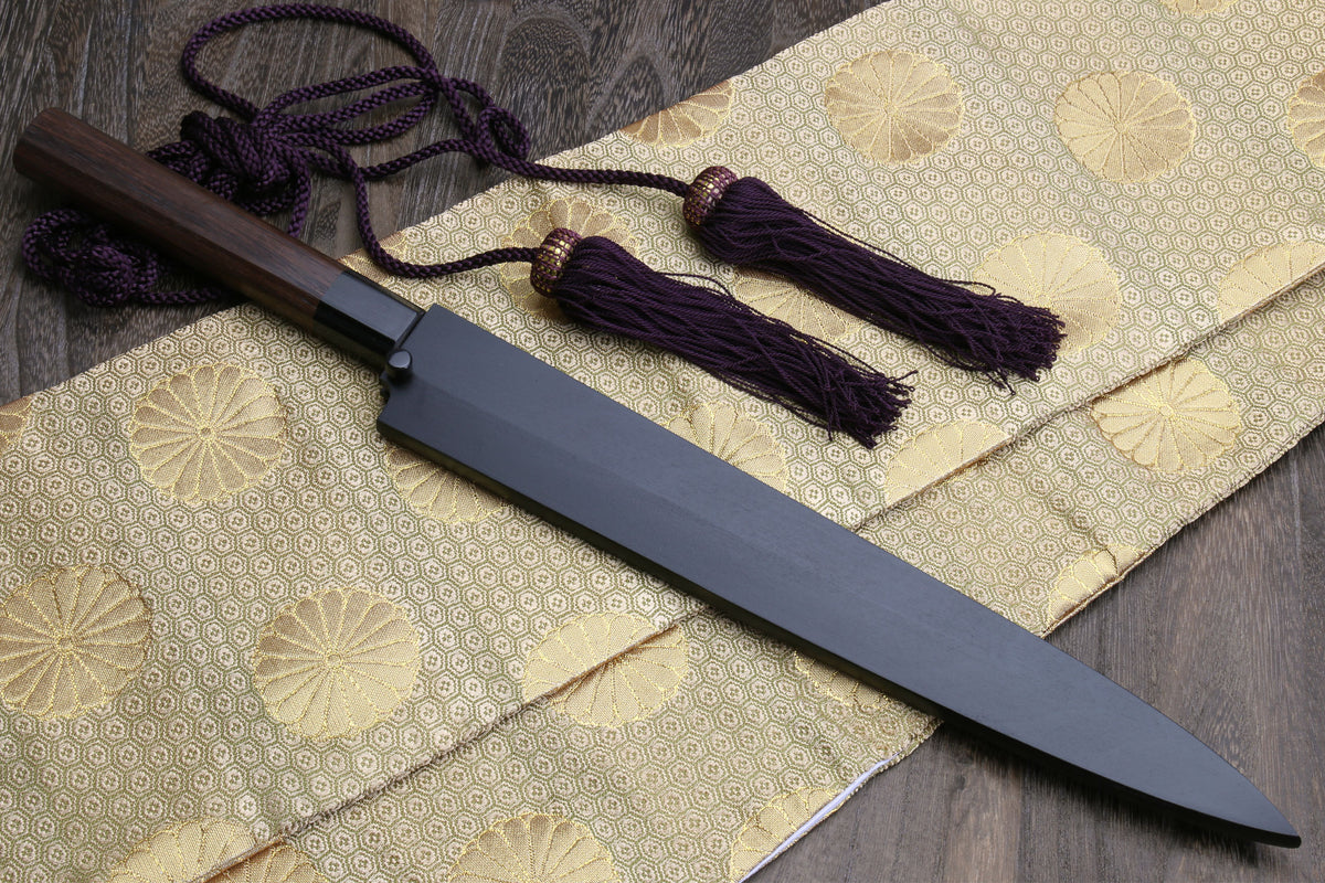 Yanagi sushi knife with dark saya, rosewood handle, and purple cord tassels