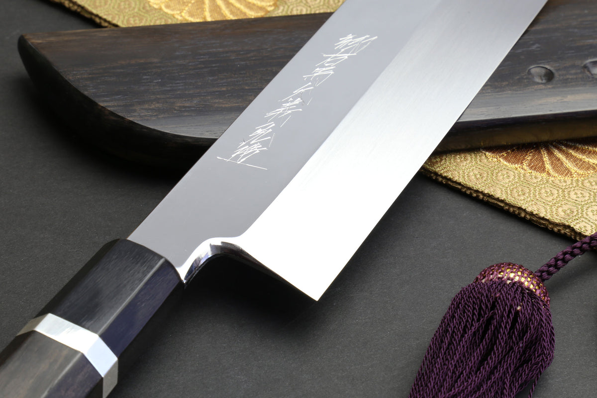 Mirror-finished white steel blade with dark ebony bolster and visible grind