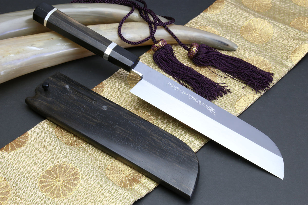 Honyaki-style chef knife with mirror-finished white steel blade and dark ebony saya
