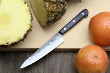 Petty utility knife with dark handle and pointed silver blade