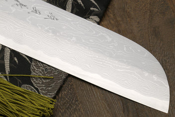 White damascus-style knife blade with wave pattern and curved tip