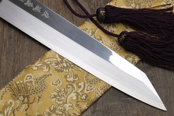Kiritsuke Japanese knife with mirror-finished single-edge blade and dark handle