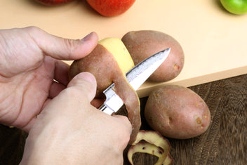 Small Damascus paring knife with dark wood handle and silver hammered blade
