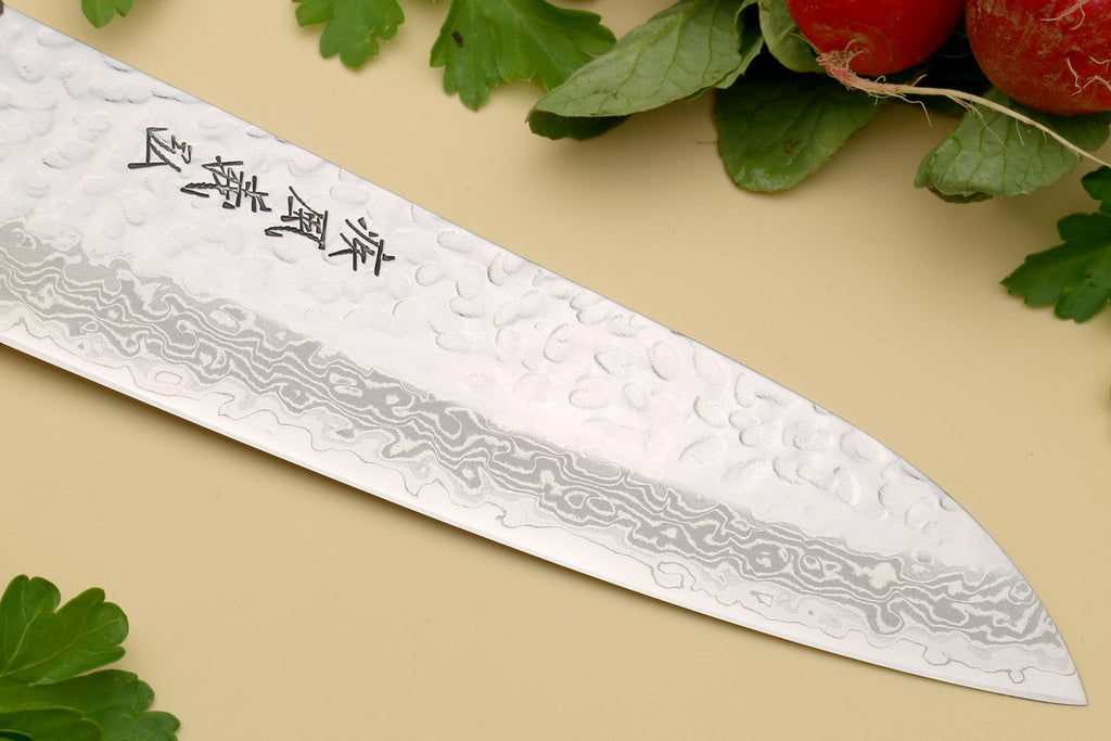 Damascus-pattern knife with dark wood handle and silver rivets