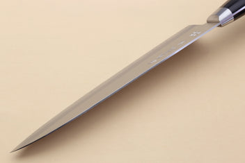 Gyuto chef knife with polished silver blade and black bolster, side profile.